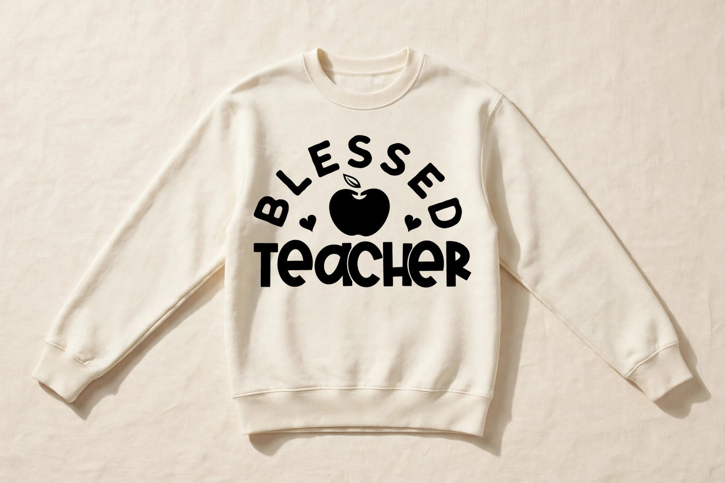 Blessed Teacher cream crewneck sweatshirt laid flat with black apple chest print