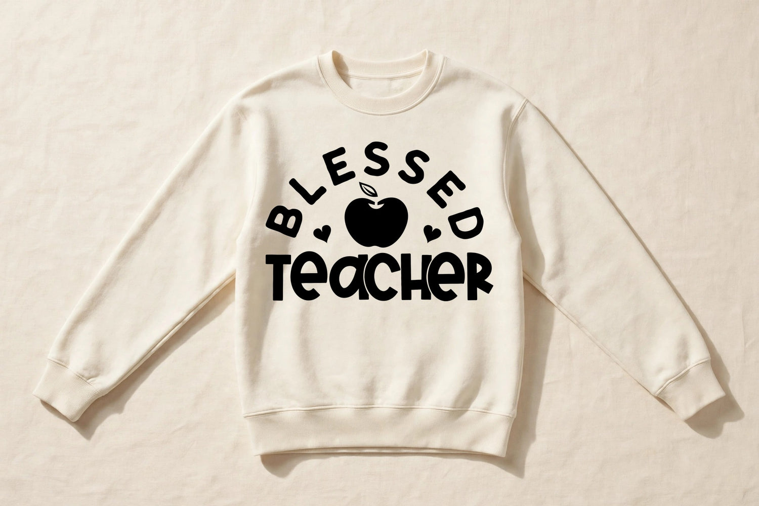 Blessed Teacher cream crewneck sweatshirt laid flat with black apple chest print